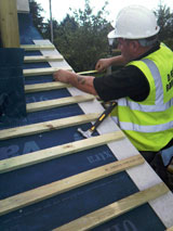 Robert Hampson at work fixing roofing slats